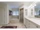This bathroom offers a tub, a sleek glass-enclosed shower, and a functional vanity with built-in shelves for easy organization at 728 Wesley Nw Dr, Atlanta, GA 30305