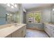 Bright bathroom featuring double sinks, white cabinets, and plenty of natural light at 728 Wesley Nw Dr, Atlanta, GA 30305