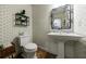 Elegant powder room featuring designer wallpaper, a modern mirror, and a pedestal sink at 728 Wesley Nw Dr, Atlanta, GA 30305