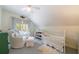 The Bedroom features a crib and chair near a window for light, offering a cozy and functional space for baby at 728 Wesley Nw Dr, Atlanta, GA 30305