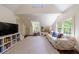 Spacious bonus room featuring a wall of shelves, hardwood floors, and a seating area at 728 Wesley Nw Dr, Atlanta, GA 30305