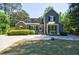 Charming two-story home with manicured lawn, stone patio, and bay window, perfect for outdoor entertaining at 728 Wesley Nw Dr, Atlanta, GA 30305