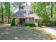 Charming exterior elevation featuring a stone chimney, shingled roof and lots of trees at 728 Wesley Nw Dr, Atlanta, GA 30305