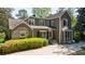 Elegant home featuring a stone patio, lush greenery, and classic architectural details for inviting curb appeal at 728 Wesley Nw Dr, Atlanta, GA 30305
