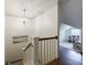 Upper hallway featuring white railings and view into playroom featuring hardwood floors that provides both safety and style at 728 Wesley Nw Dr, Atlanta, GA 30305