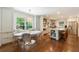 Bright kitchen with dining area features large windows, stainless steel appliances, a center island, and custom cabinetry at 728 Wesley Nw Dr, Atlanta, GA 30305