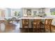 Bright kitchen featuring a large island, marble countertops, open shelving, and adjacent breakfast nook with large windows at 728 Wesley Nw Dr, Atlanta, GA 30305