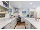 Bright kitchen featuring marble countertops, stainless steel appliances, and a modern range hood over the stovetop at 728 Wesley Nw Dr, Atlanta, GA 30305