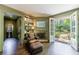 Inviting living room with a leather chair, stone fireplace, and an outdoor view at 728 Wesley Nw Dr, Atlanta, GA 30305