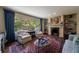 Elegant living room featuring large windows, a fireplace, and custom shelving for added charm and functionality at 728 Wesley Nw Dr, Atlanta, GA 30305