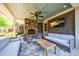 Relaxing outdoor patio featuring a stone fireplace, comfortable seating, and a ceiling fan at 728 Wesley Nw Dr, Atlanta, GA 30305