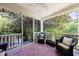 Inviting porch with comfortable seating, offering a relaxing outdoor space surrounded by beautiful greenery at 728 Wesley Nw Dr, Atlanta, GA 30305