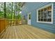 New wood deck with railings next to a home with light-blue vinyl siding at 1697 Ramblewood Way, Snellville, GA 30078