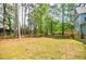 Large backyard features mature trees, well-maintained lawn, and a wooden deck at 1697 Ramblewood Way, Snellville, GA 30078