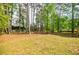 Large backyard features mature trees, well-maintained lawn, and a wooden deck at 1697 Ramblewood Way, Snellville, GA 30078