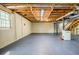 Unfinished basement with painted floor, exposed ductwork, and a single window for natural light at 1697 Ramblewood Way, Snellville, GA 30078