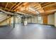 Spacious unfinished basement with painted floor, exposed ceiling, and access to stairs at 1697 Ramblewood Way, Snellville, GA 30078