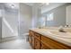 Spacious bathroom with double vanity, a shower, and ample lighting at 1697 Ramblewood Way, Snellville, GA 30078