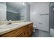 Bathroom features double sinks with a combination tub and shower at 1697 Ramblewood Way, Snellville, GA 30078