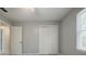 This bedroom has a window with blinds and closet doors at 1697 Ramblewood Way, Snellville, GA 30078