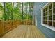 A spacious wooden deck, perfect for outdoor entertaining, with blue siding at 1697 Ramblewood Way, Snellville, GA 30078