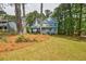 Charming two-story home with a inviting front porch, well-maintained lawn, and mature shade trees in a quiet neighborhood at 1697 Ramblewood Way, Snellville, GA 30078