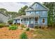 Charming two-story home with a inviting front porch and walkway surrounded by mature trees and well-kept landscaping at 1697 Ramblewood Way, Snellville, GA 30078