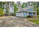 Home exterior with a driveway leading to a two-car garage and manicured landscaping at 1697 Ramblewood Way, Snellville, GA 30078