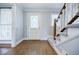 Inviting foyer with hardwood floors, staircase and a front door with decorative glass at 1697 Ramblewood Way, Snellville, GA 30078