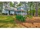 Well-maintained lawn and landscaping surround this charming two-story home with light blue siding at 1697 Ramblewood Way, Snellville, GA 30078