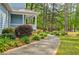 Charming home featuring beautiful landscaping, a welcoming front porch, and a serene, wooded setting at 1697 Ramblewood Way, Snellville, GA 30078
