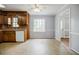 Eat-in kitchen with wood cabinets, white appliances, and a bright window overlooking a green backyard at 1697 Ramblewood Way, Snellville, GA 30078