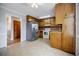 Eat-in kitchen with wood cabinets, stainless steel refrigerator and easy access to other rooms at 1697 Ramblewood Way, Snellville, GA 30078