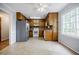 Bright eat-in kitchen with wood cabinets, stainless steel refrigerator, and large window at 1697 Ramblewood Way, Snellville, GA 30078