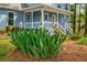 Lush landscaping frames the front of this light blue two-story home, offering curb appeal at 1697 Ramblewood Way, Snellville, GA 30078
