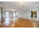 Spacious living room with hardwood floors, brick fireplace and classic trim, connecting to kitchen at 1697 Ramblewood Way, Snellville, GA 30078