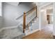 Carpeted staircase with wooden handrail and white spindles leading to the upper level at 1697 Ramblewood Way, Snellville, GA 30078