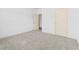Bright bedroom featuring neutral carpet, white walls, and two doors at 2075 Villa Spring Ct, Dacula, GA 30019