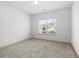 Carpeted bedroom featuring natural light from the large window at 2075 Villa Spring Ct, Dacula, GA 30019