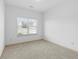 Bedroom featuring natural light from the large window and neutral carpet at 2075 Villa Spring Ct, Dacula, GA 30019