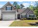 Charming gray two-story home featuring a two-car garage and well-maintained landscaping at 2075 Villa Spring Ct, Dacula, GA 30019