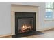 A cozy fireplace with a stone hearth, perfect for relaxing evenings at 2075 Villa Spring Ct, Dacula, GA 30019