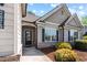 Home's inviting entrance features a well-lit door and manicured landscaping at 2075 Villa Spring Ct, Dacula, GA 30019
