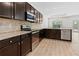 Modern kitchen with dark wood cabinets, granite countertops, and stainless steel appliances at 2075 Villa Spring Ct, Dacula, GA 30019