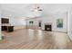 Open-concept living room with wood floors, a fireplace, and access to the kitchen at 2075 Villa Spring Ct, Dacula, GA 30019