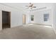 Spacious main bedroom with tray ceiling, ceiling fan, and walk-in closet at 2075 Villa Spring Ct, Dacula, GA 30019