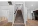 Carpeted staircase with white walls and wood trim, leading to the upper level at 2075 Villa Spring Ct, Dacula, GA 30019