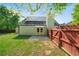 A home exterior with solar panels, complemented by a well-maintained lawn and backyard at 30 Village Dr, Cartersville, GA 30121