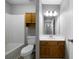 Cozy bathroom featuring a tub and shower combo, a mirror with vanity lights, and wooden cabinets at 30 Village Dr, Cartersville, GA 30121