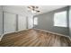 Bright and spacious bedroom featuring a ceiling fan, wood-look floors, and ample closet space at 30 Village Dr, Cartersville, GA 30121